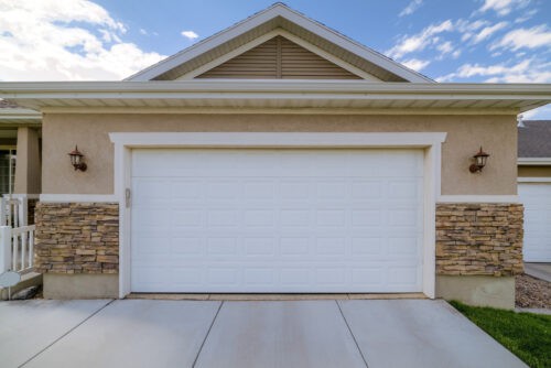 Facade of a home with front view of the closed white garage door